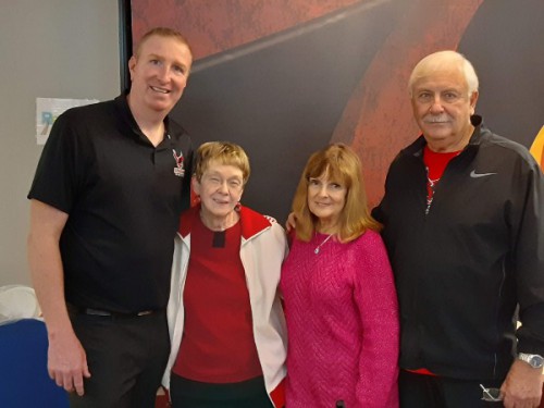 Sue stands and smiles with Coach Clifford and Jack and Joanne Rosati.