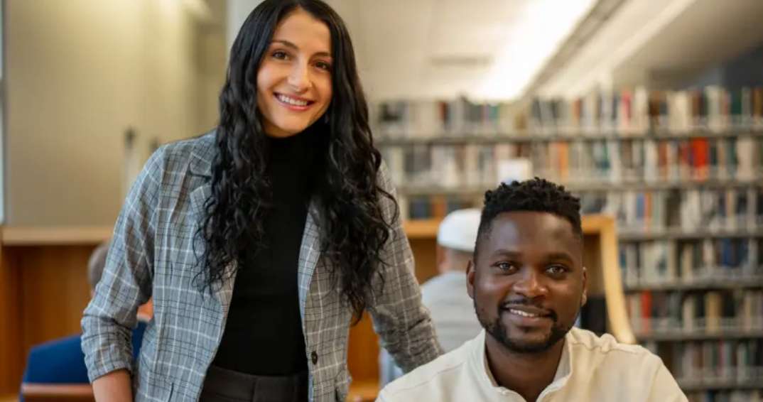 Two students smiling