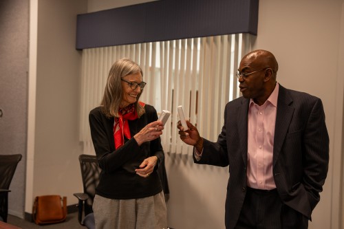 Dr. Berry and President Hayles touch their icecream sandwiches together in celebration