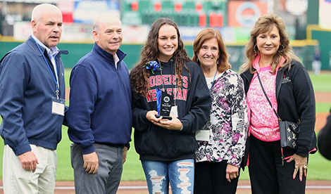 Brynn smiles with Jerry Flynn award