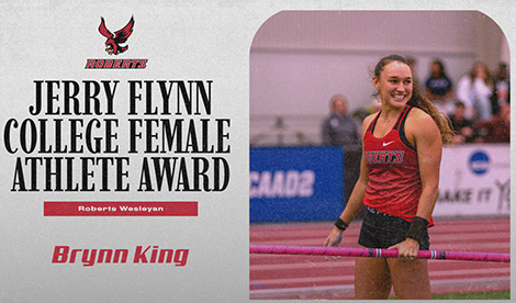 Brynn King smiles while holding pole vault pole. To her left are the words Jerry Flynn College Female Athlete Award Roberts Wesleyan Brynn King and the Roberts athletics logo