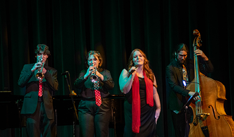 A group plays instruments and sings