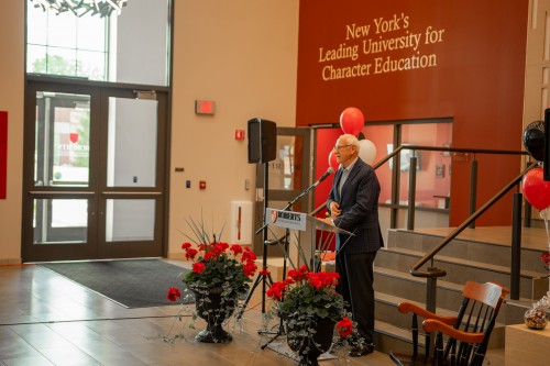 A man speaks at Dave Basinger's retirement ceremony