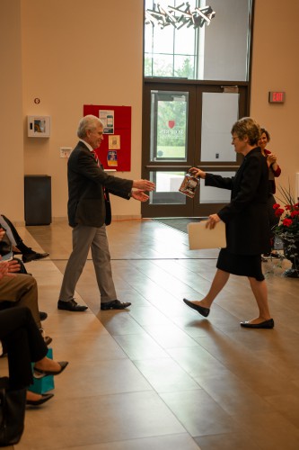 Dave Basinger receives a gift during his retirement celebration