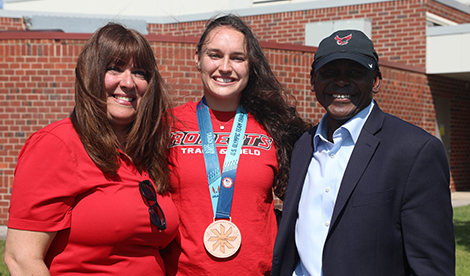 Brynn smiles with President Hayles and his wife, Maryann Hayles