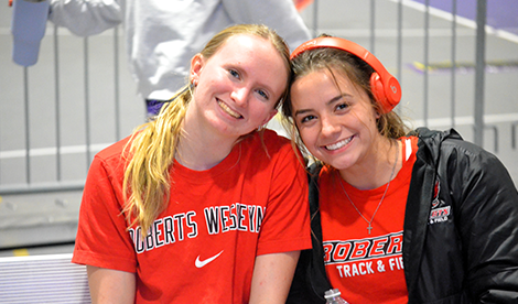 2 young women smile at a track meet