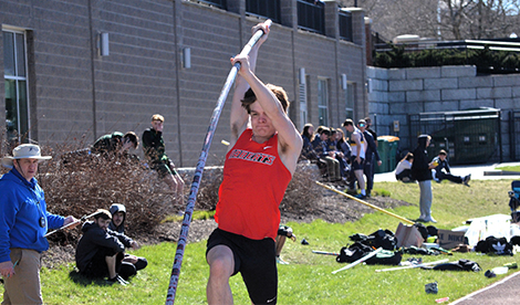 A young man makes a pole vault attempt