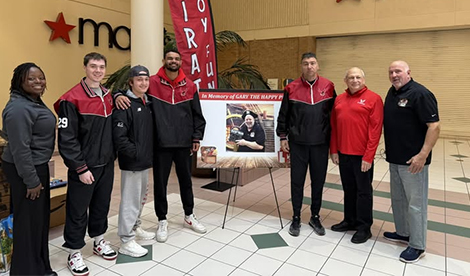 Members and coaches of the men's lacrosse team, help at the toy drive, along with athletics leadership.