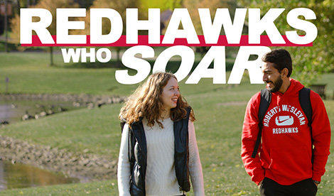 2 students smile outside on campus. The words Redhawks Who Soar