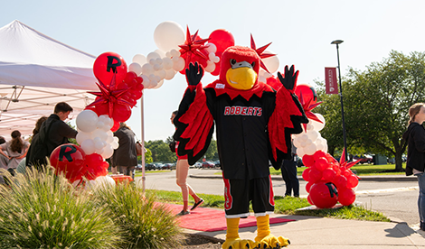 Reggie the Redhawk poses as new students arrive to campus