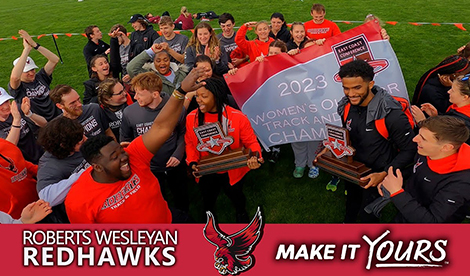 The Roberts track team celebrates a win. Underneath is a red bar that says 