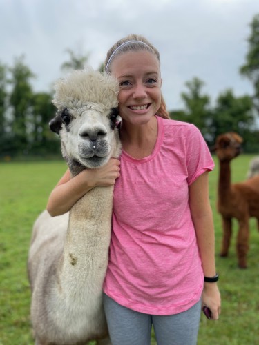 Sam with an alpaca at the alpaca farm