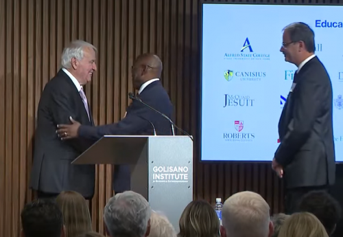 Tom Golisano and President Hayles shake hands