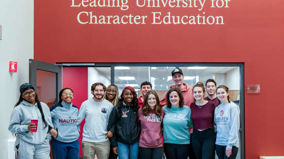 students at roberts in front of character education sign