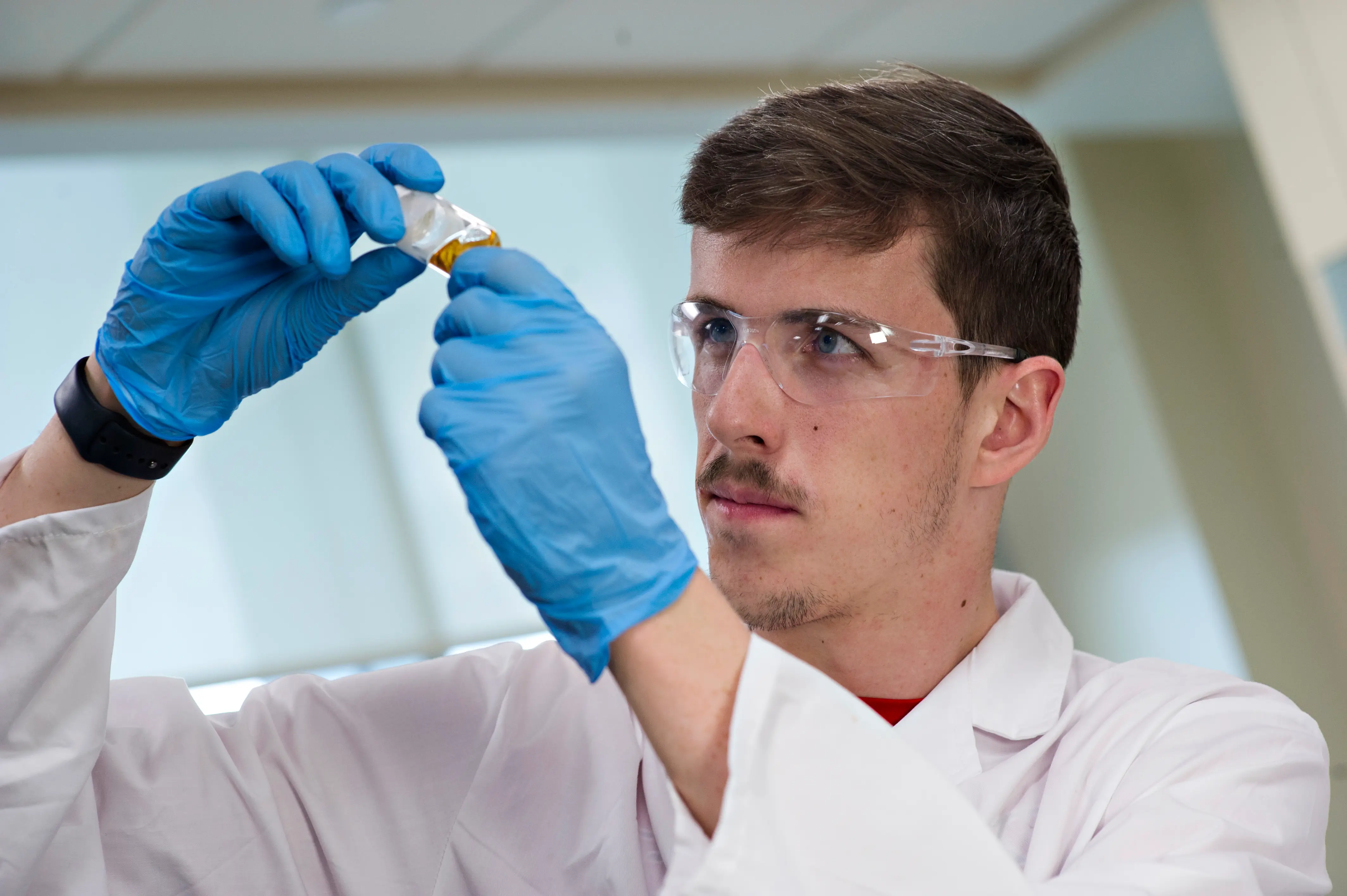 Derik looking at a sample