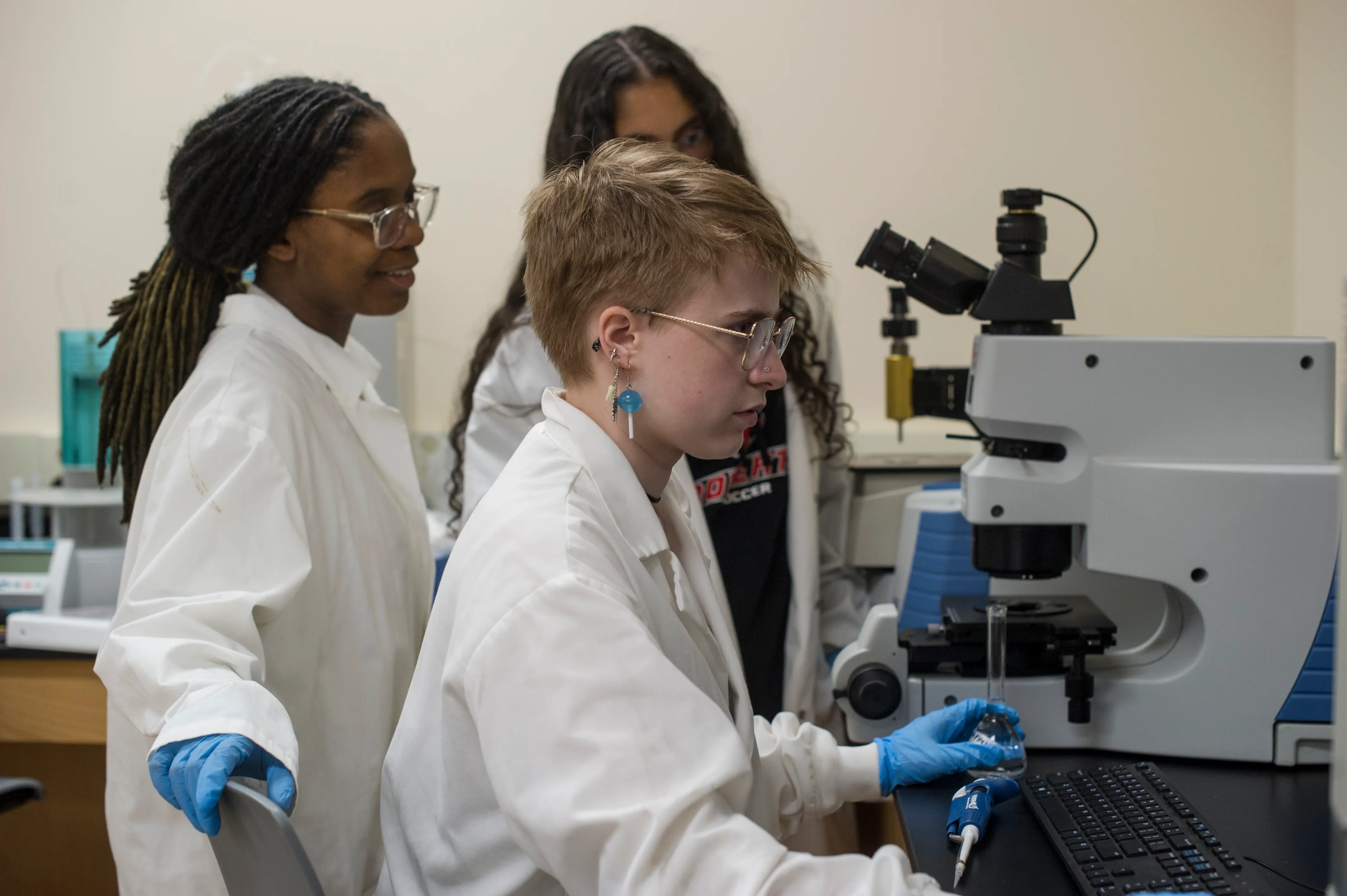3 students using an instrument